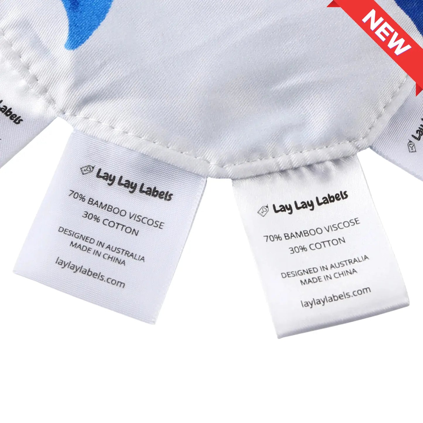 Close-up of silk and woven sensory labels on blue baby minis showing texture contrast