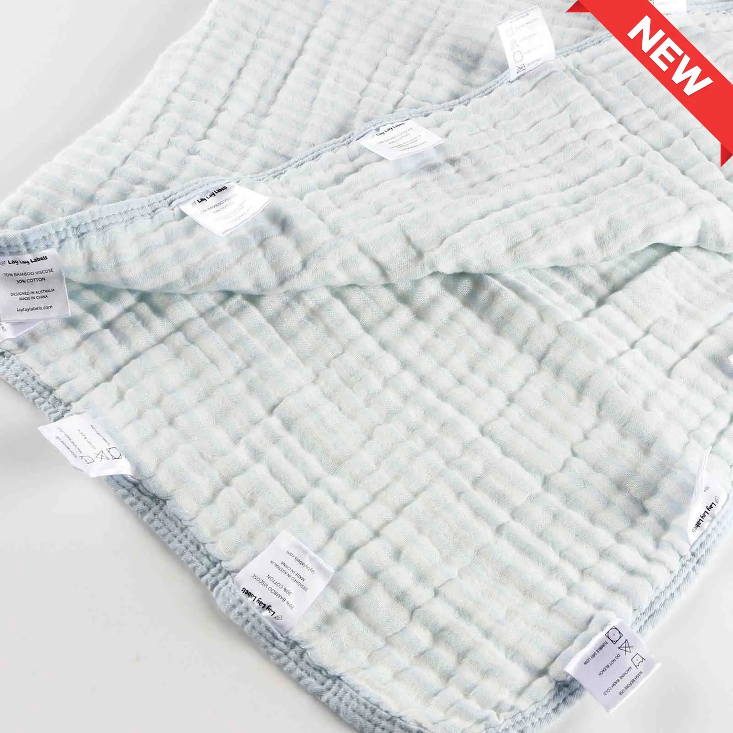 Blue baby blanket with soft fabric and smooth silk labels designed for calming comfort