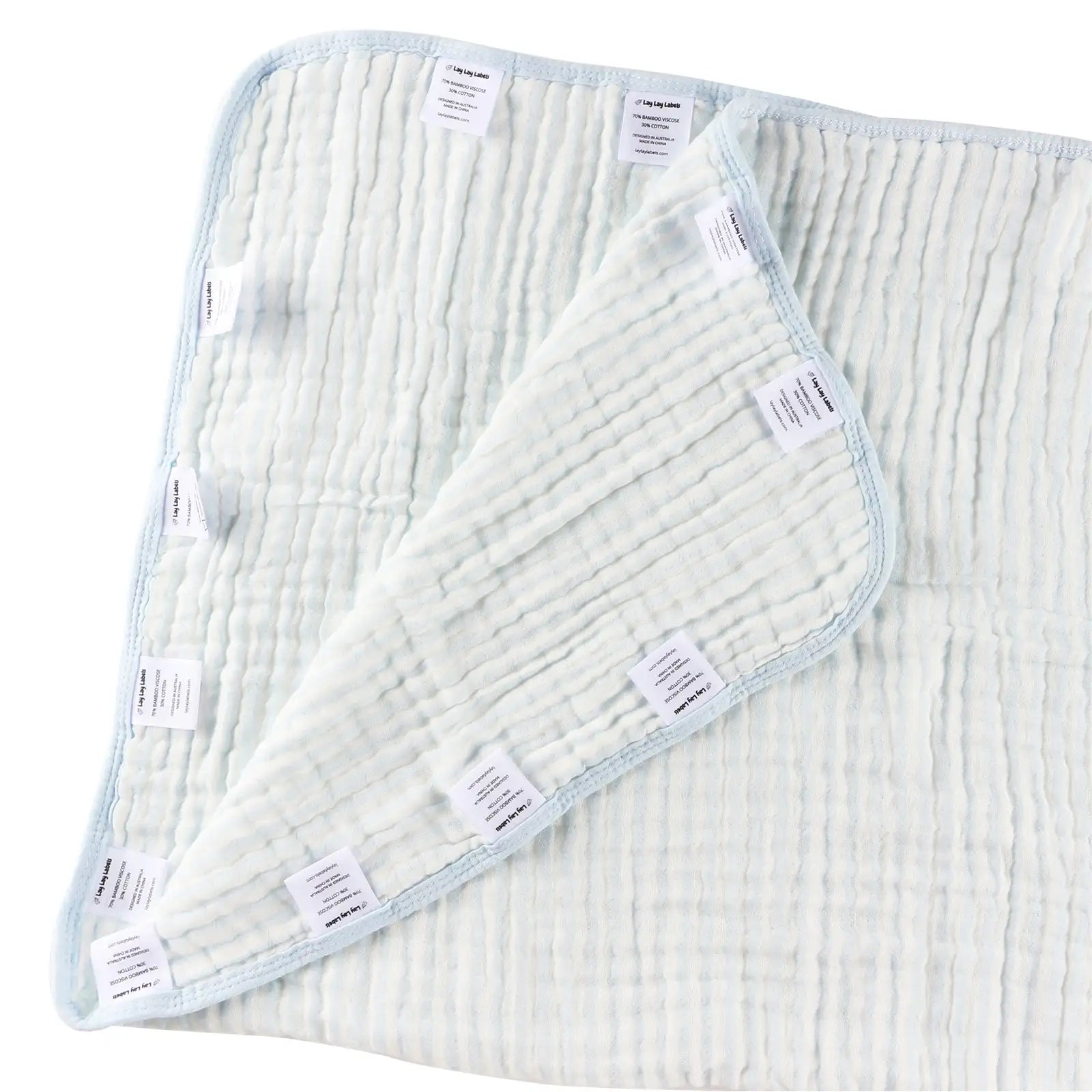 Blue baby blanket with soft fabric and textured woven labels for sensory comfort