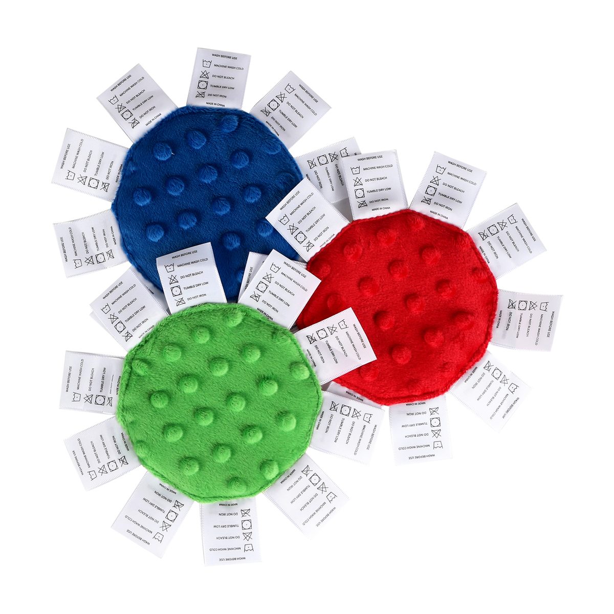The backs of the three Minis in blue, red and green minky dot, edged with woven labels