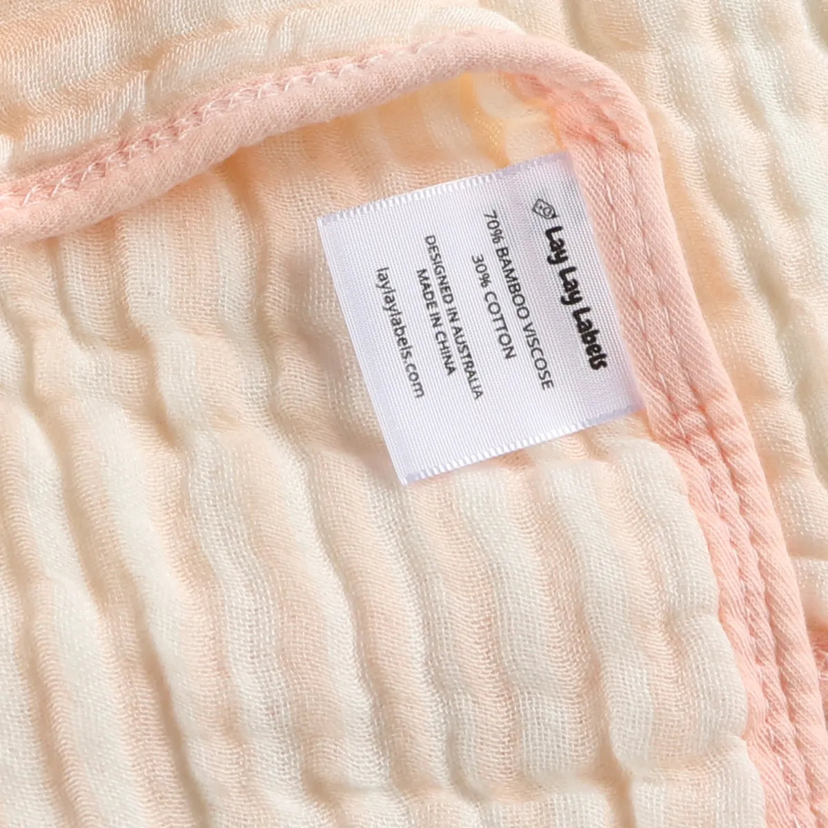 Close-up of a Lay Lay label sewn onto the blanket's edge