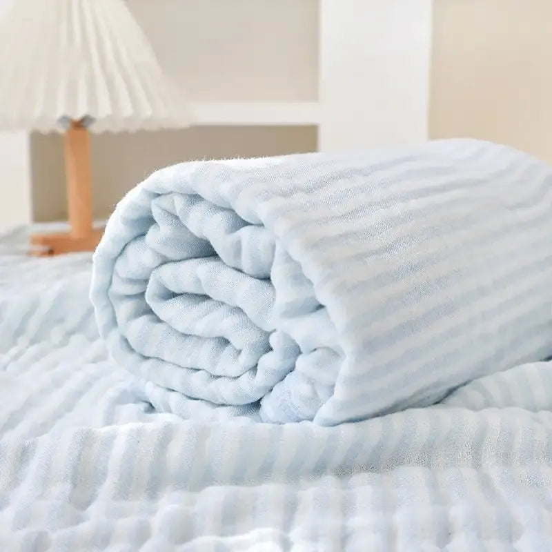 The blanket rolled up on a bed