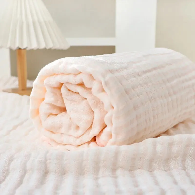 The blanket rolled up on a bed